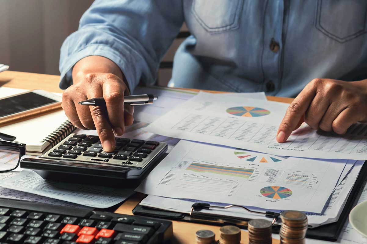 accounting-concept-businesswoman-working-using-calculator-@1200