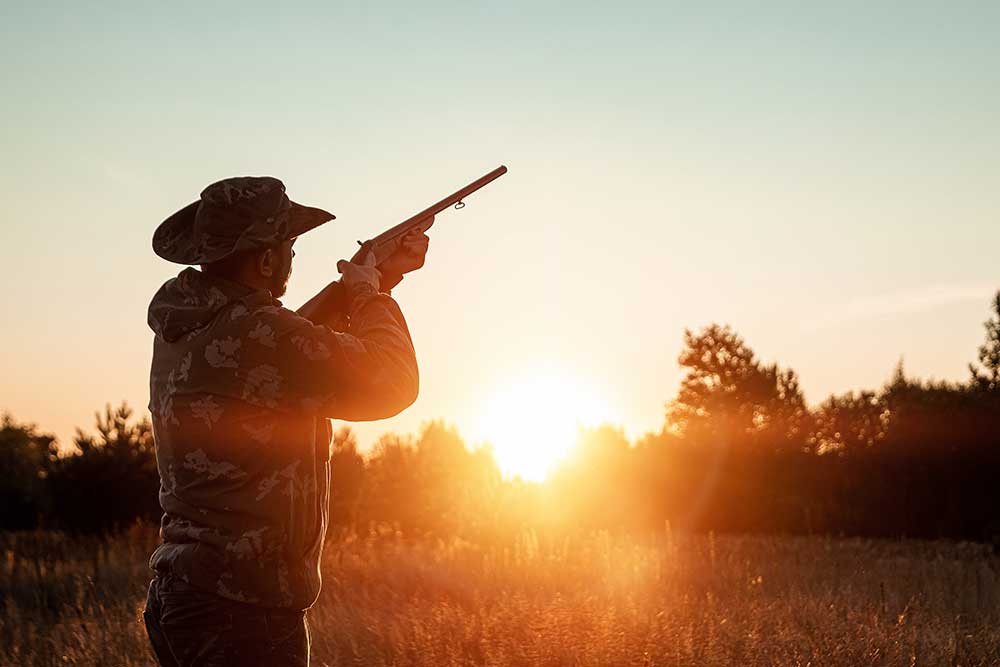 silhouette-hunter-cowboy-hat-with-gun-his-hands-beautiful-sunset